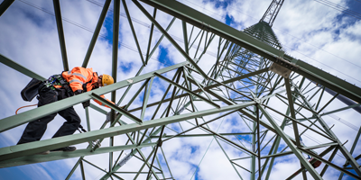 man climbing an electricity pylon